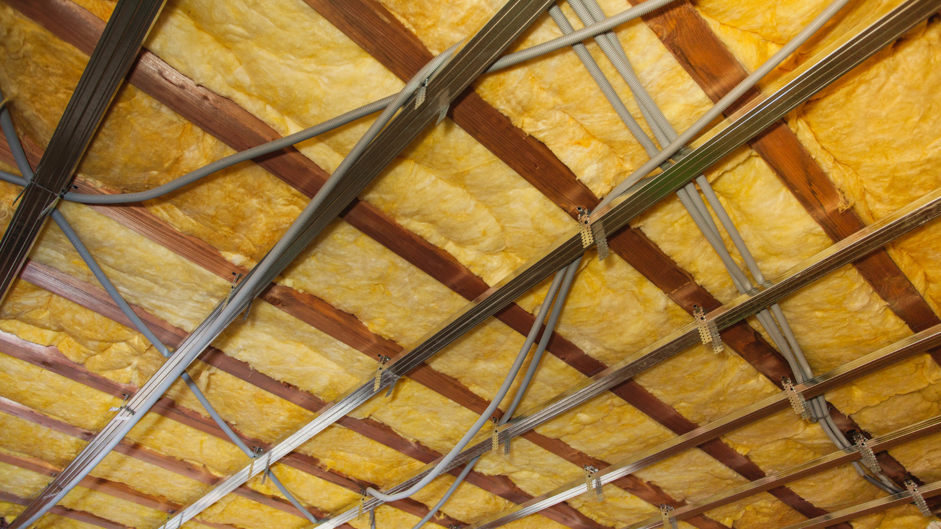 a close up of a ceiling with insulation and wires .