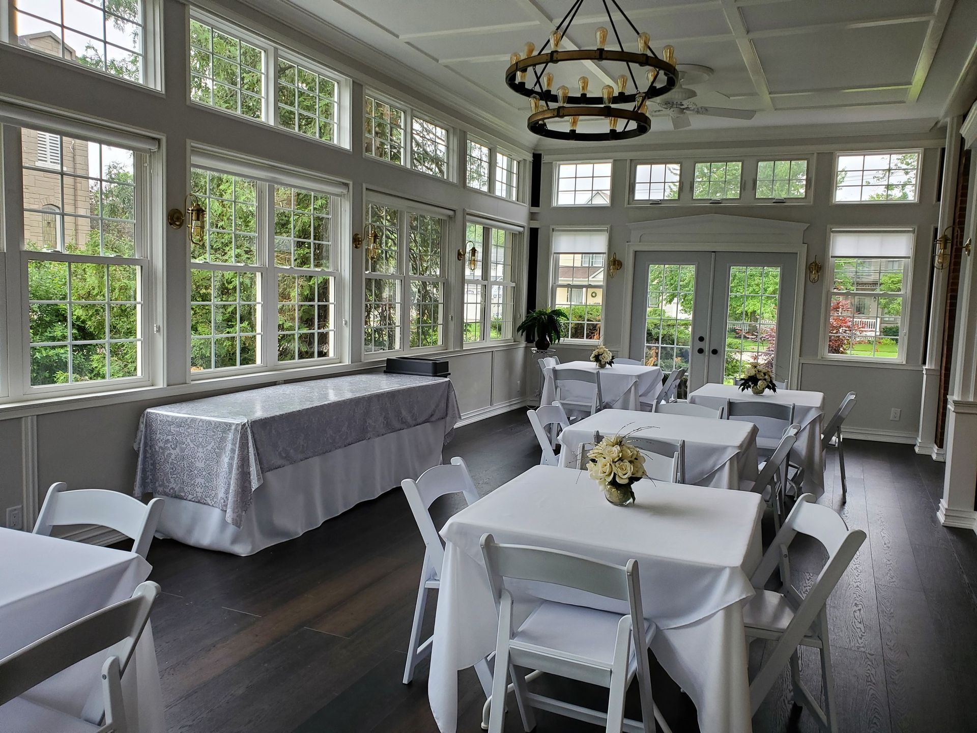 A large room with tables and chairs and a chandelier