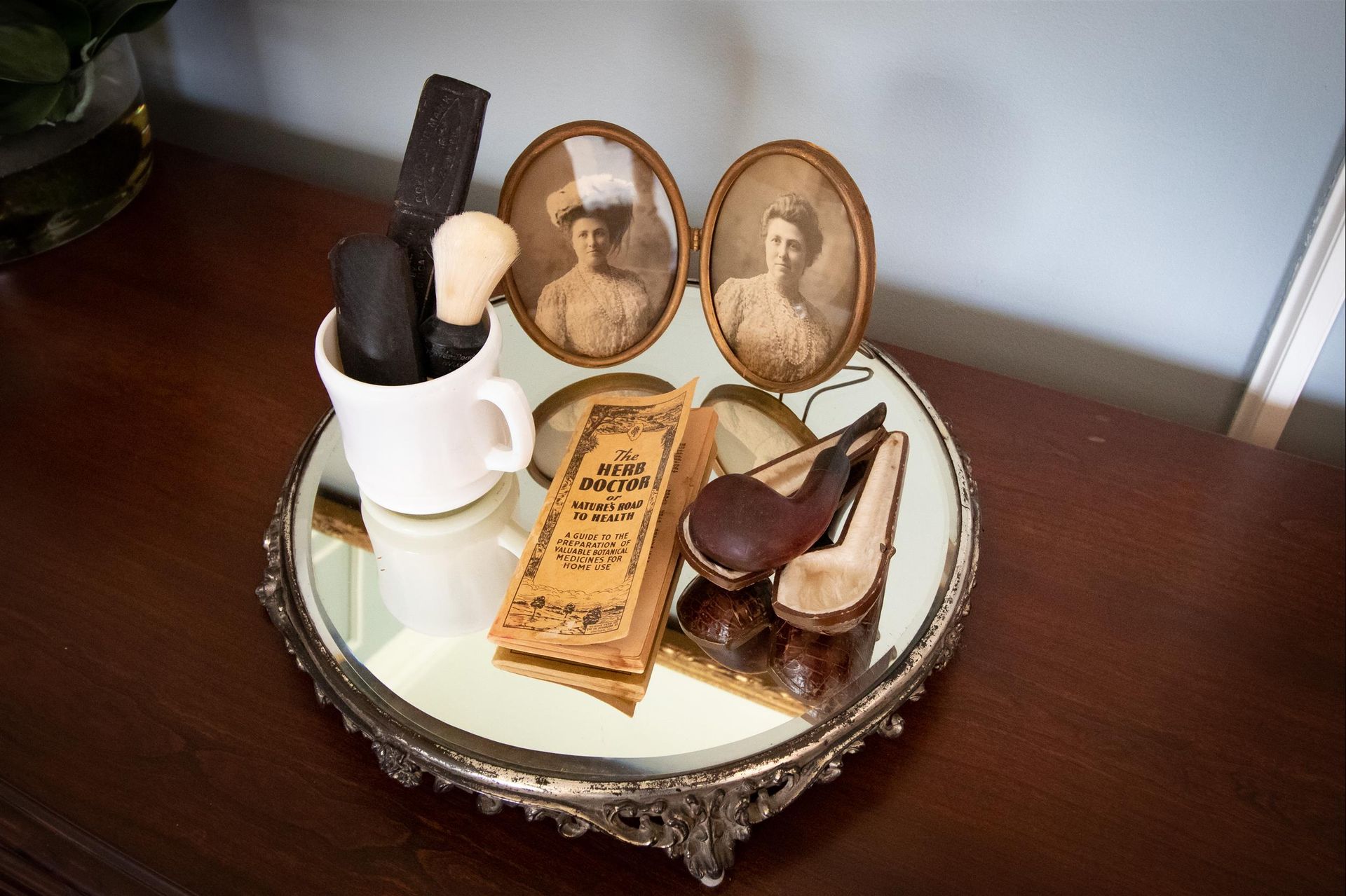 A tray with a picture of a woman and a pipe on it