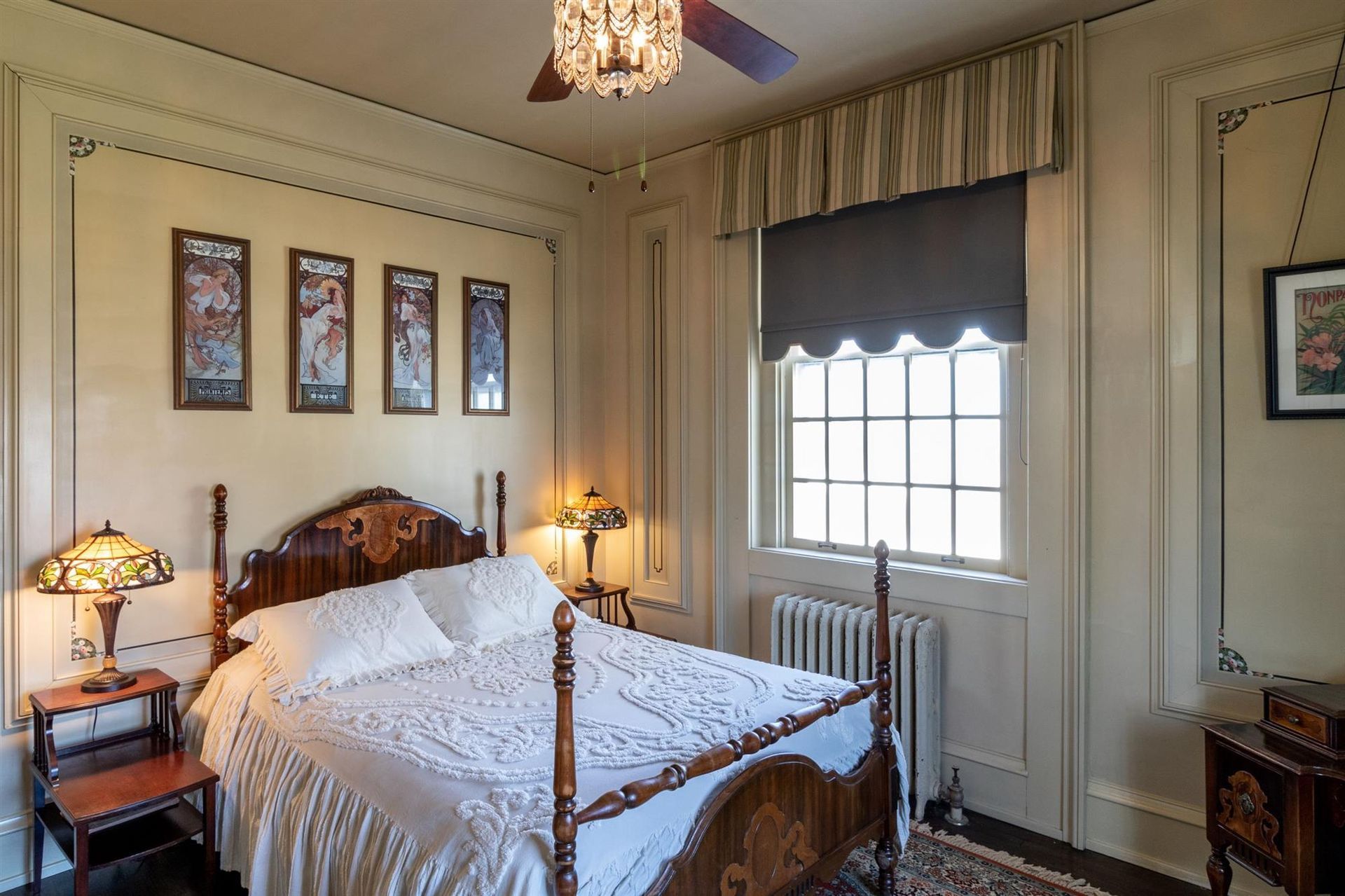 A bedroom with a bed and a ceiling fan