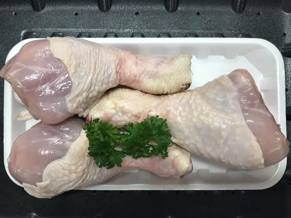 Raw Chicken Legs on A Styrofoam Tray with Parsley — Holiday Coast Meat & Smallgoods in Coffs Harbour, NSW