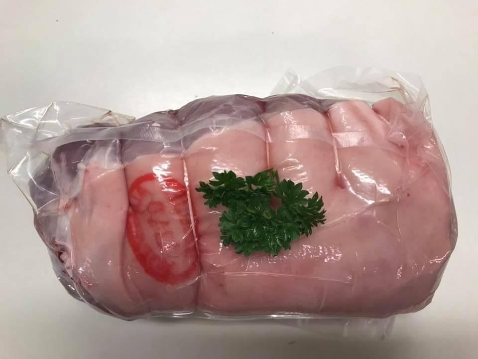 A Piece of Pork Wrapped in Plastic with Parsley on Top — Holiday Coast Meat & Smallgoods in Clarence Valley, NSW