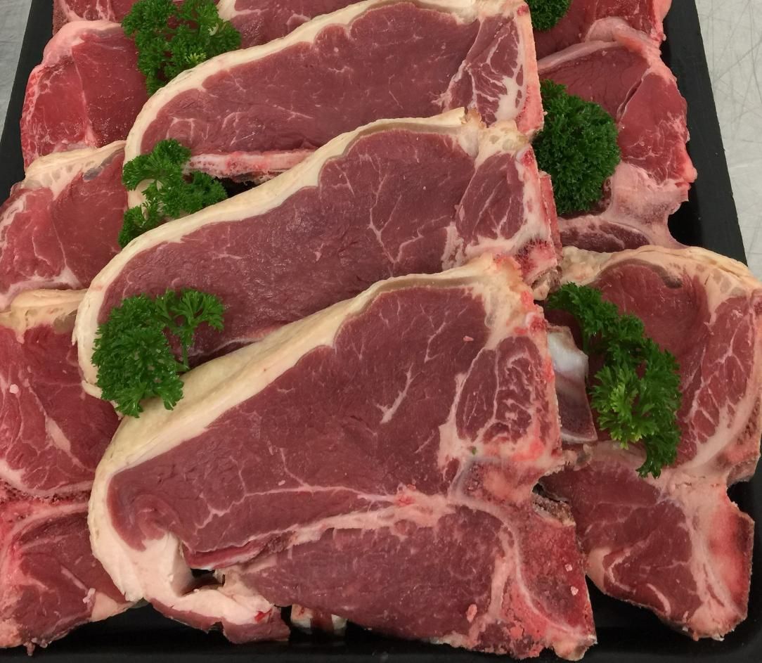 A Tray of Raw Pork Chops with Parsley on Top — Holiday Coast Meat & Smallgoods in Coffs Harbour, NSW