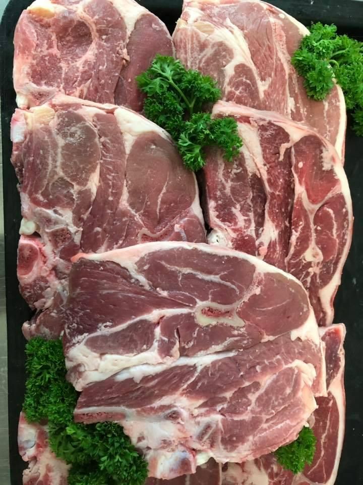 A Tray of Raw Lamb Chops with Parsley on Top — Holiday Coast Meat & Smallgoods in Coffs Harbour, NSW
