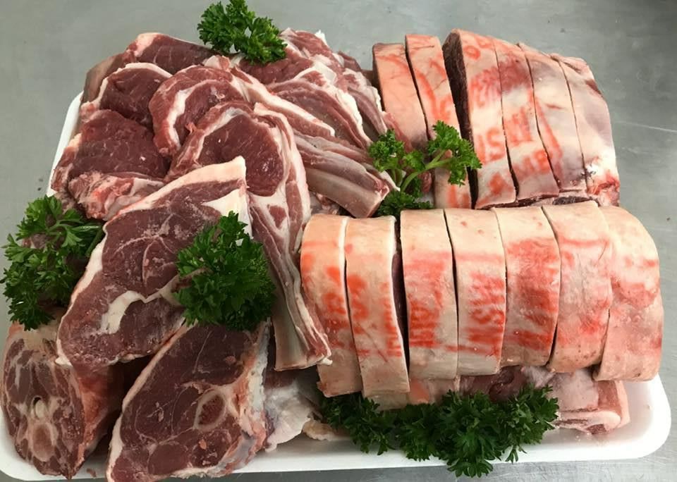 A White Tray Filled with Lamb and Parsley on A Table — Holiday Coast Meat & Smallgoods in Clarence Valley, NSW