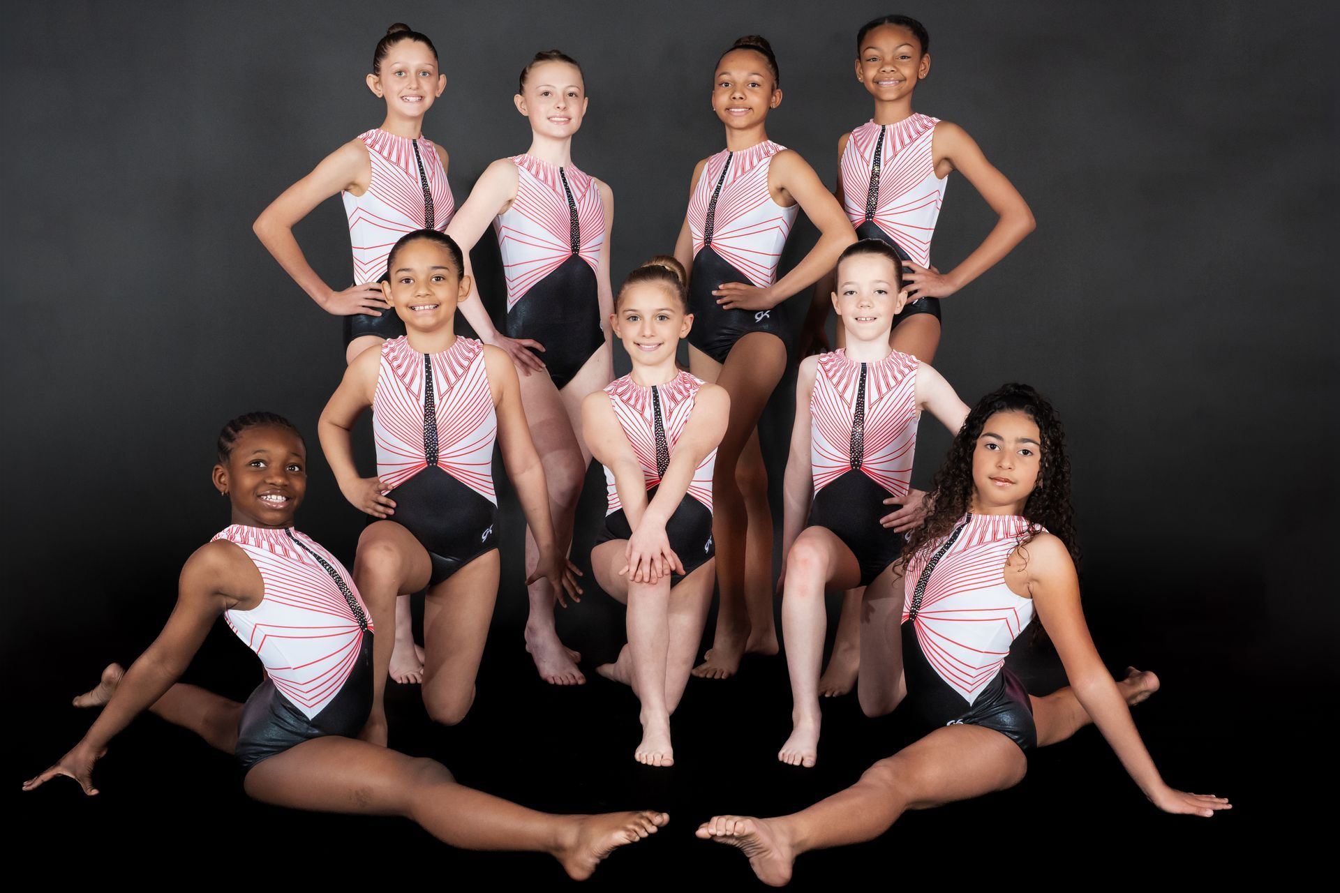 A group of young girls are posing for a picture.