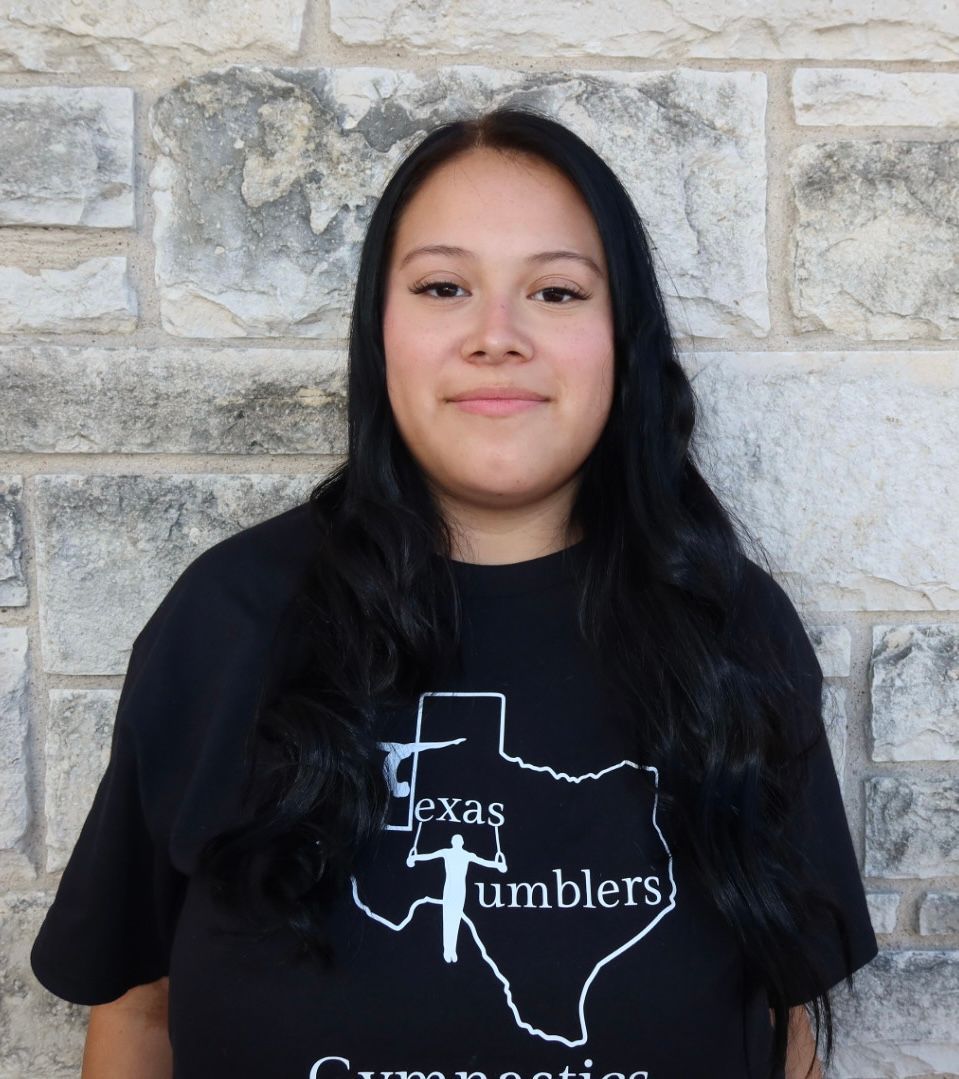 A woman is celebrating her victory with her fists in the air.