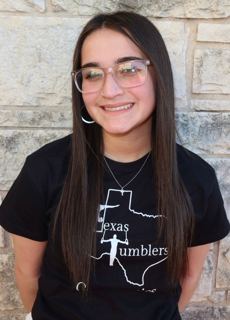 A woman is celebrating her victory with her fists in the air.