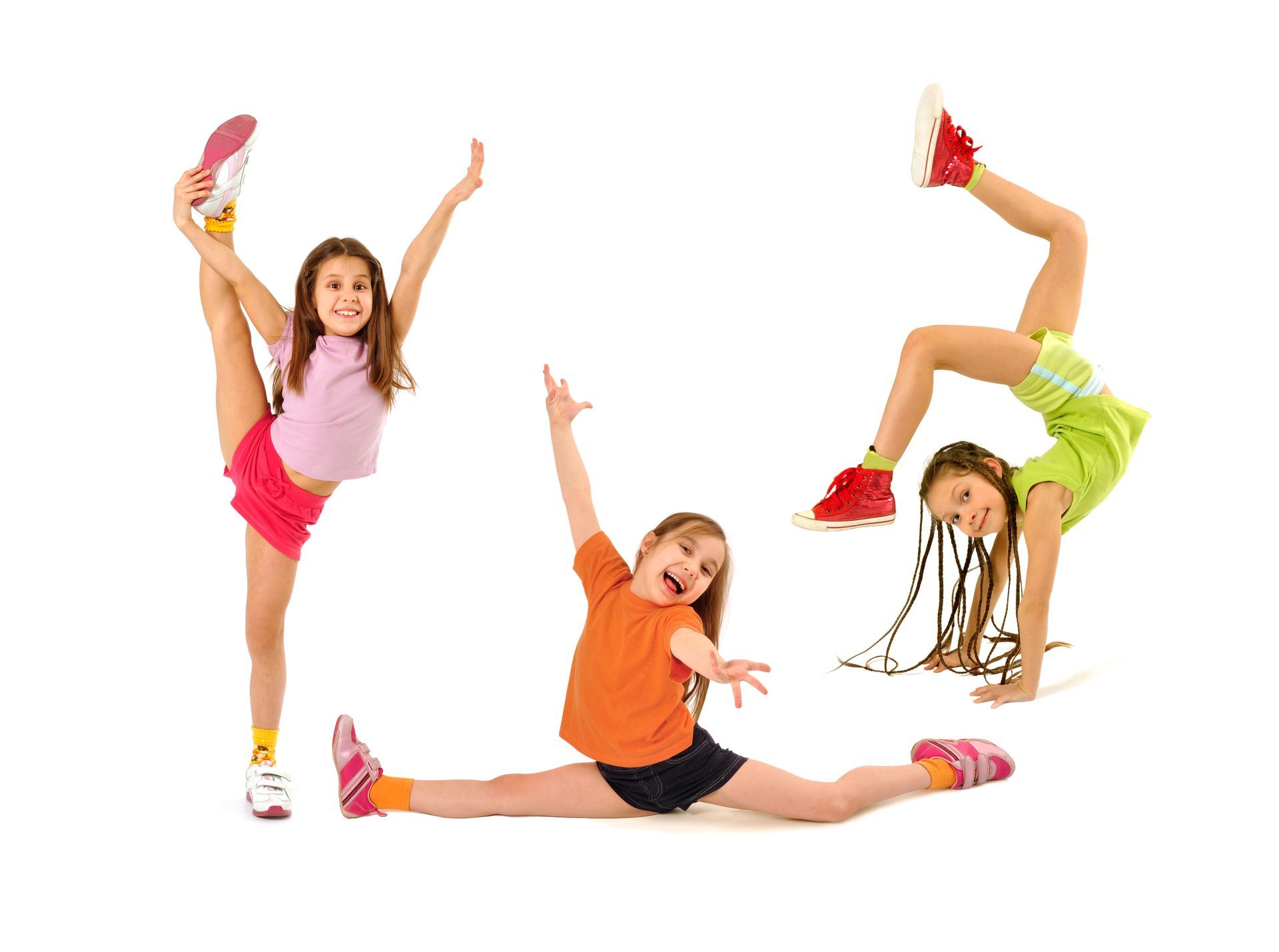 Three young girls are doing exercises on a white background.