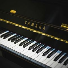 A close up of a yamaha piano keyboard