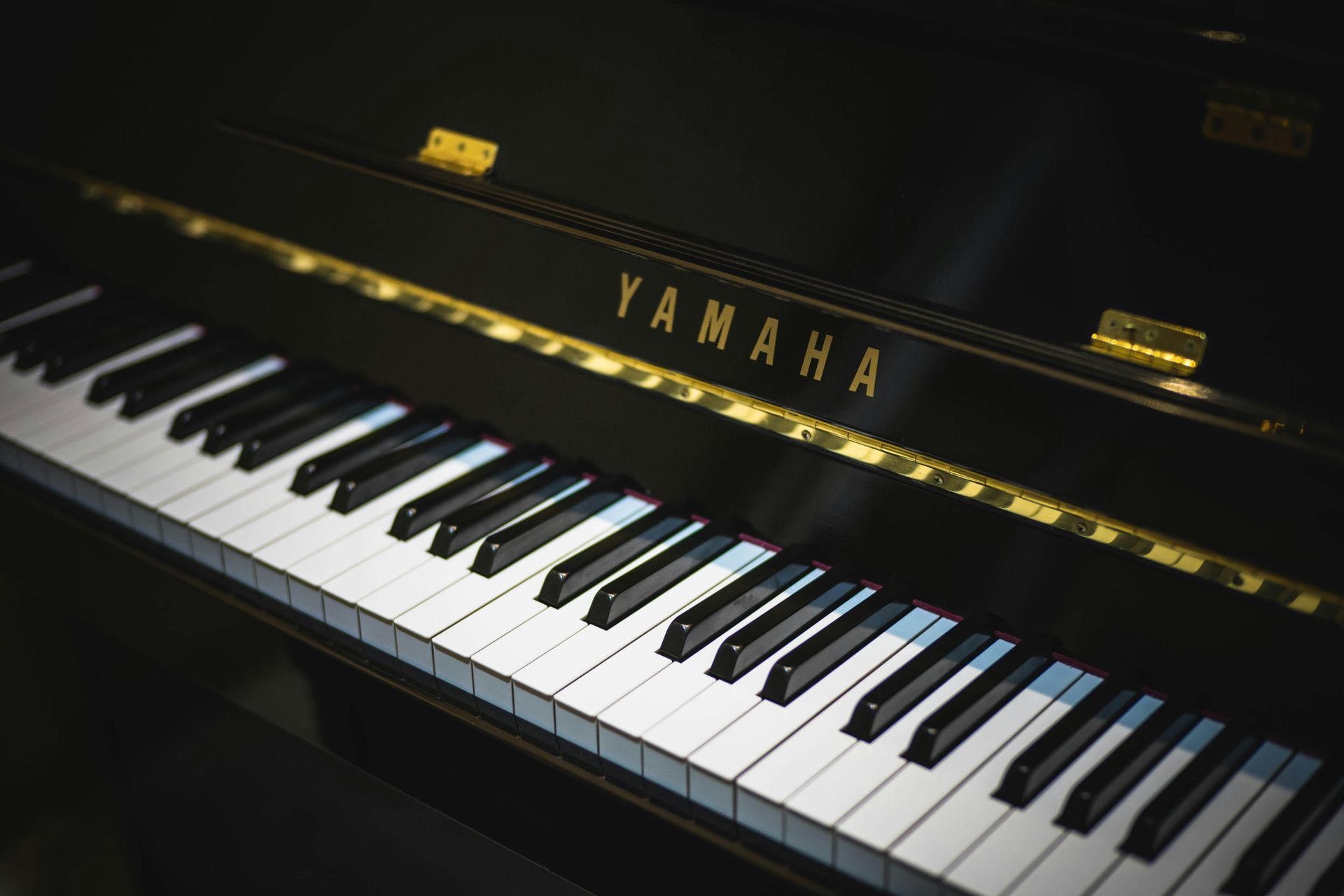 A close up of a yamaha piano keyboard