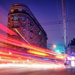 A building with a lot of windows is lit up at night