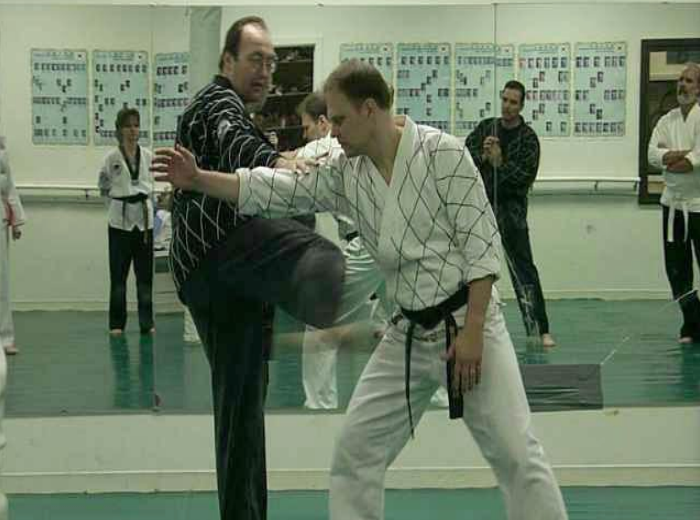 A group of people are practicing martial arts in front of a mirror.