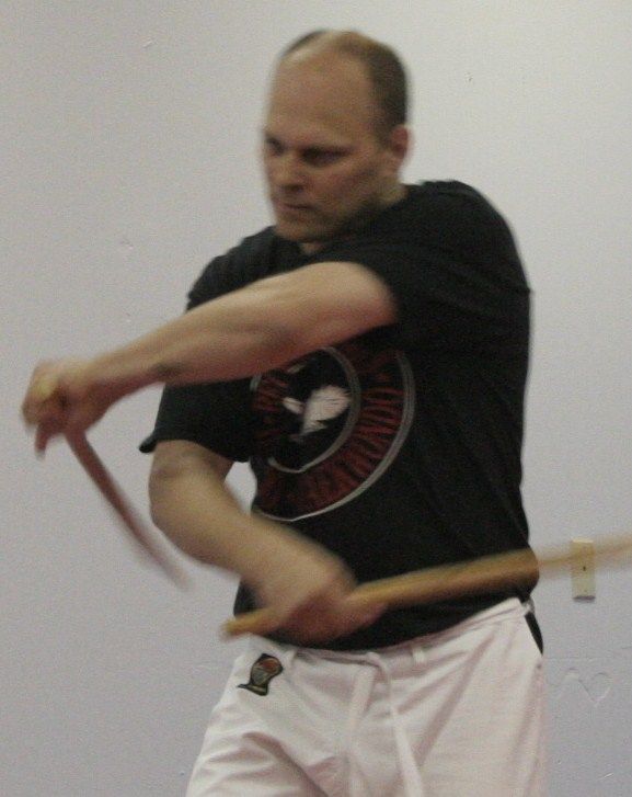 A man in a black shirt with the word karate on it