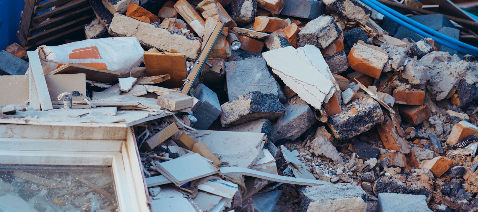Pile of rubble: bricks, concrete, wood, and debris, possibly from a demolition site.