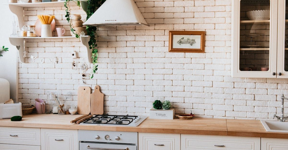 White brick kitchen with wooden countertops and cabinets.