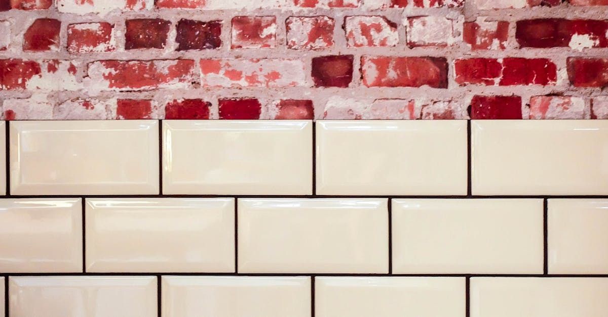 Brick wall above beige subway tiles.