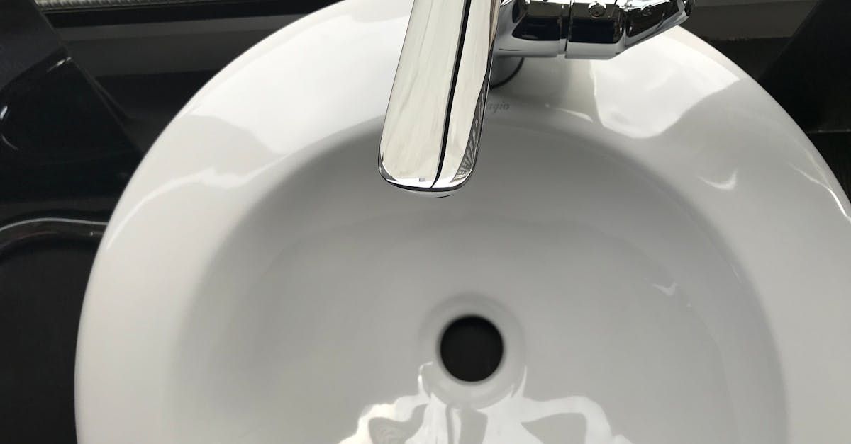 White bathroom sink with chrome faucet.