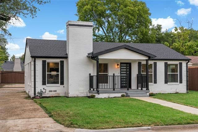 Real estate agent putting up a home sold sign.