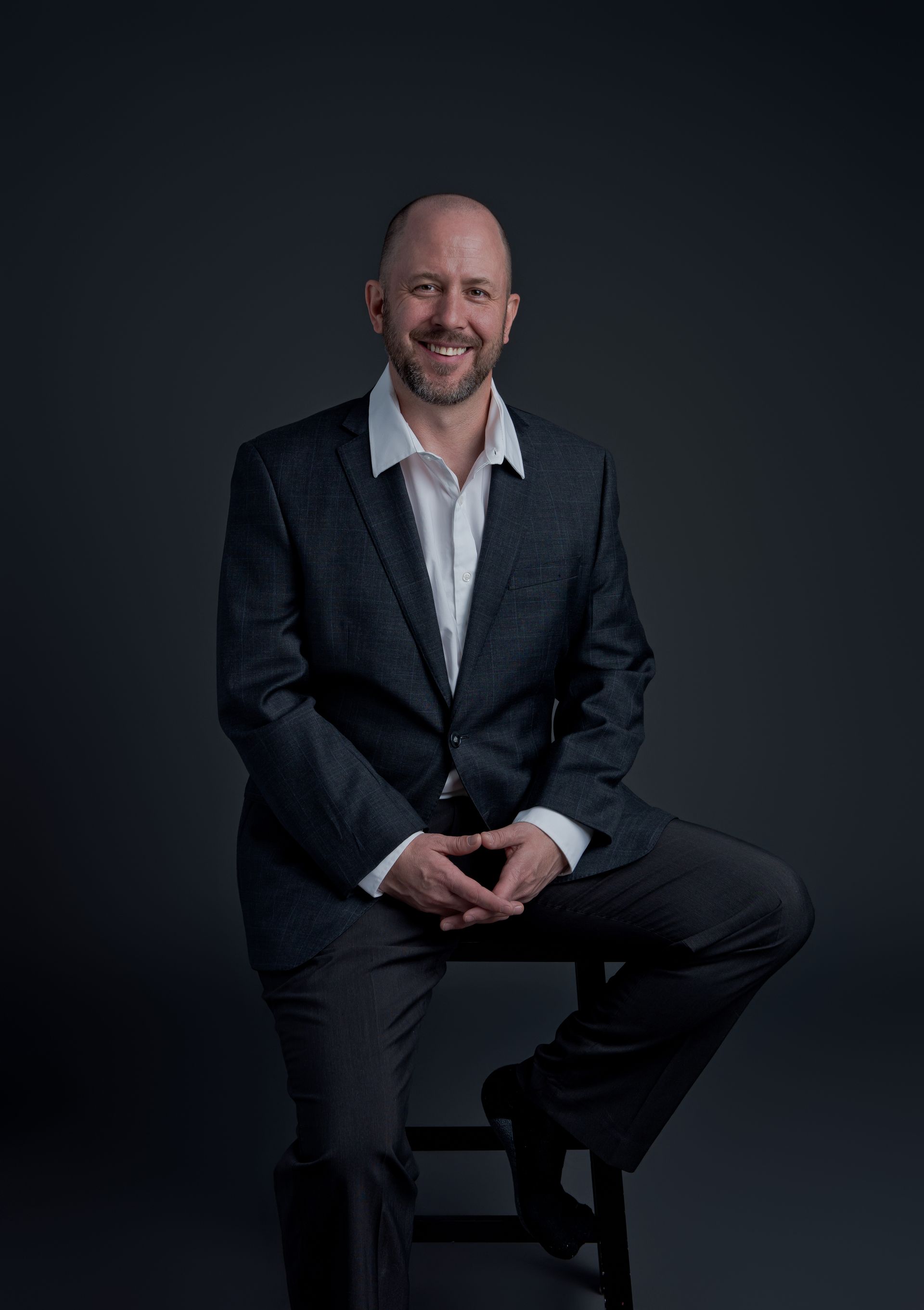 A man and a woman are standing next to each other in front of a mountain.