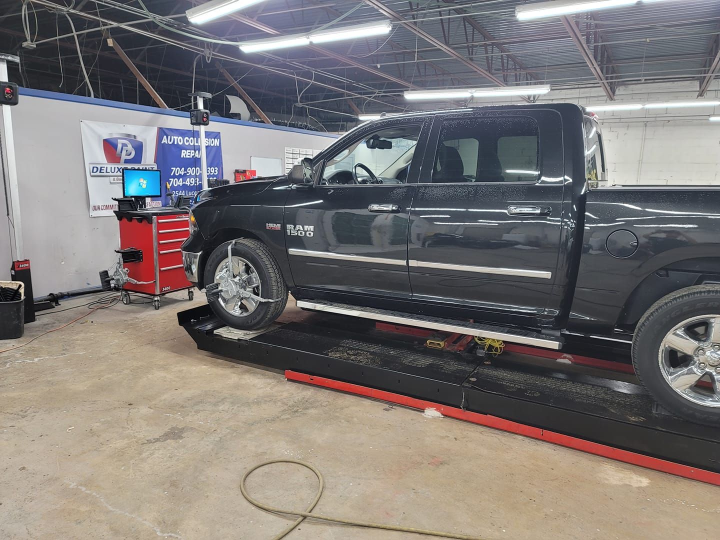 a ram truck is sitting on a lift in a garage