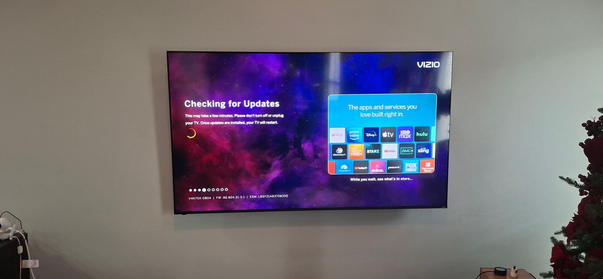 A Vizio TV on a wall displaying updates. 