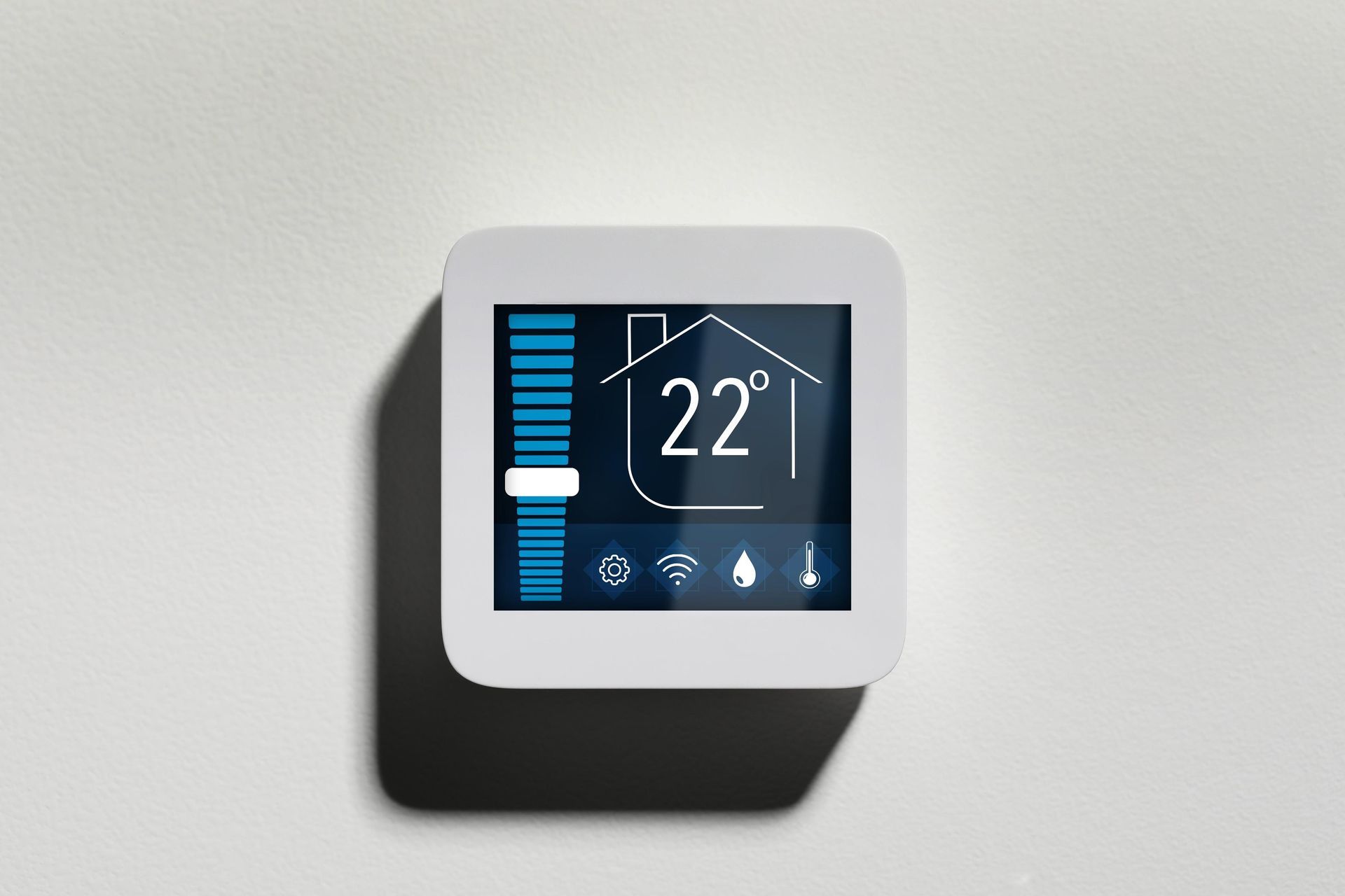 White smart thermostat on a wall displaying 22 degrees Celsius and settings.