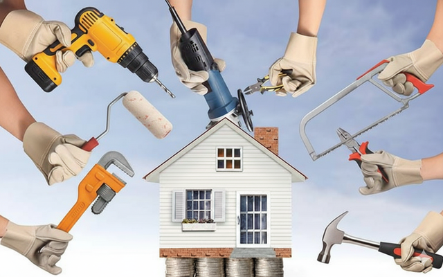 Hands with tools surround a small house on stacked coins, suggesting home improvement and finances.