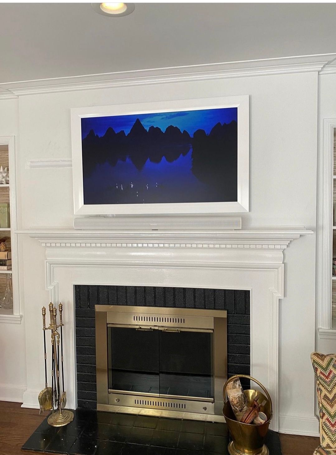Frame TV mounted over fireplace by Yonkers TV Mounting Service.