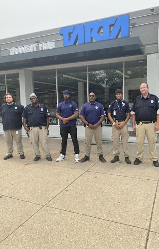 Group of security guards standing in front of a 