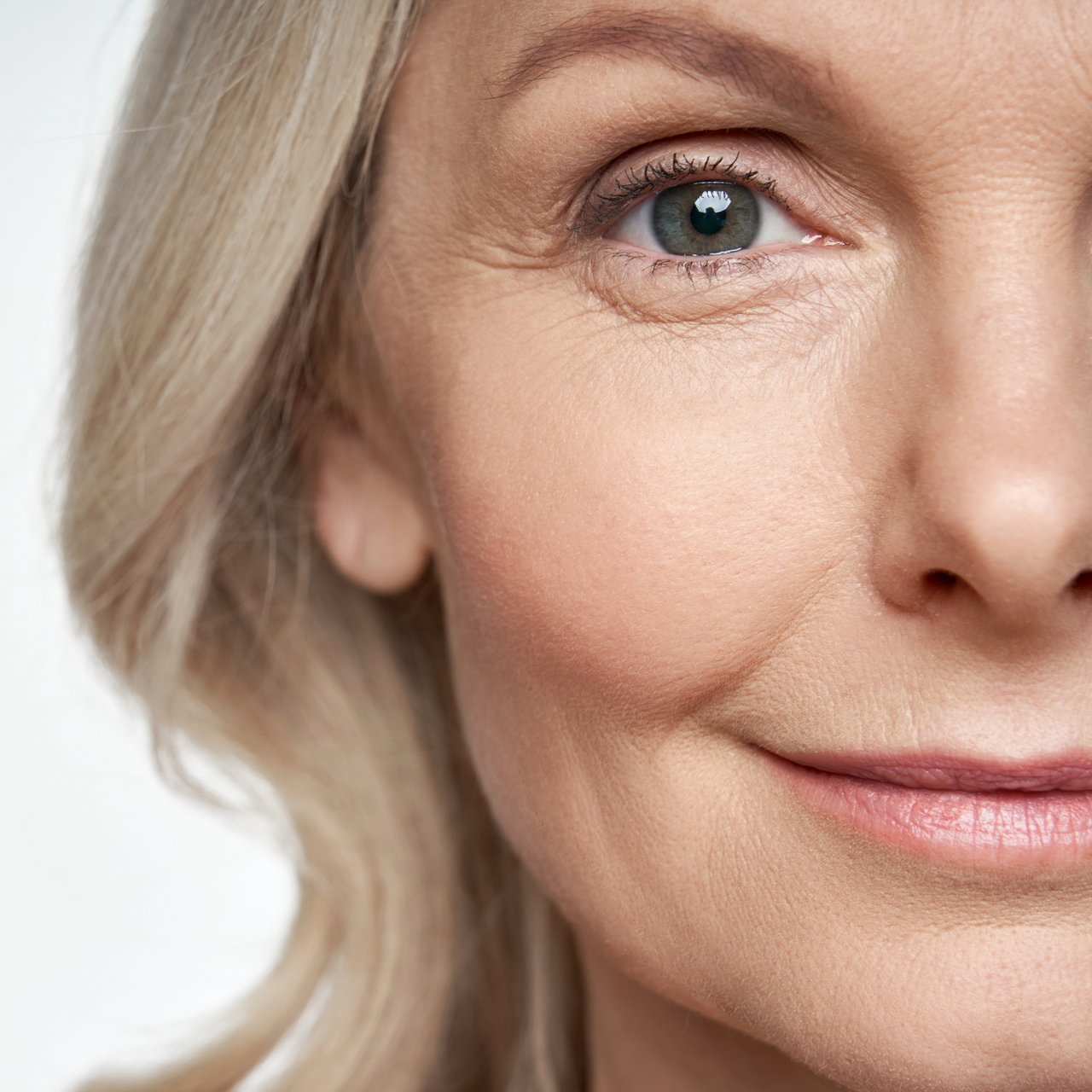 A close up of a woman's face with a smile on her face.