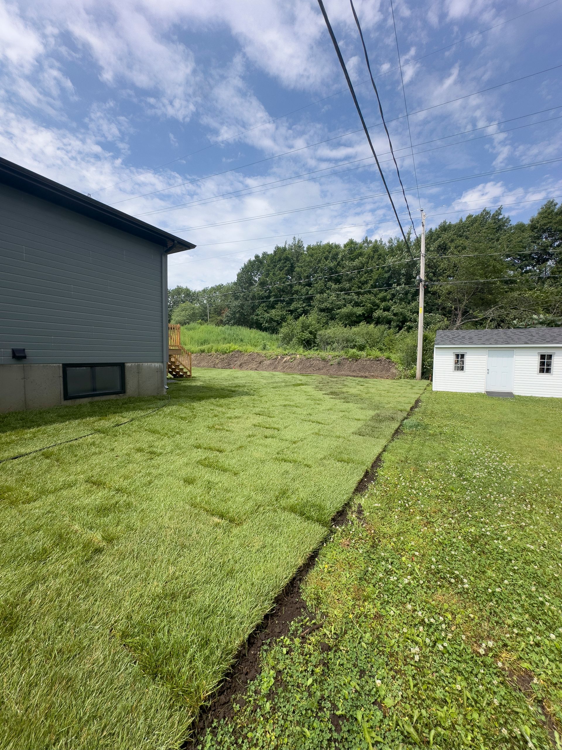 Une maison avec beaucoup d'herbe devant.