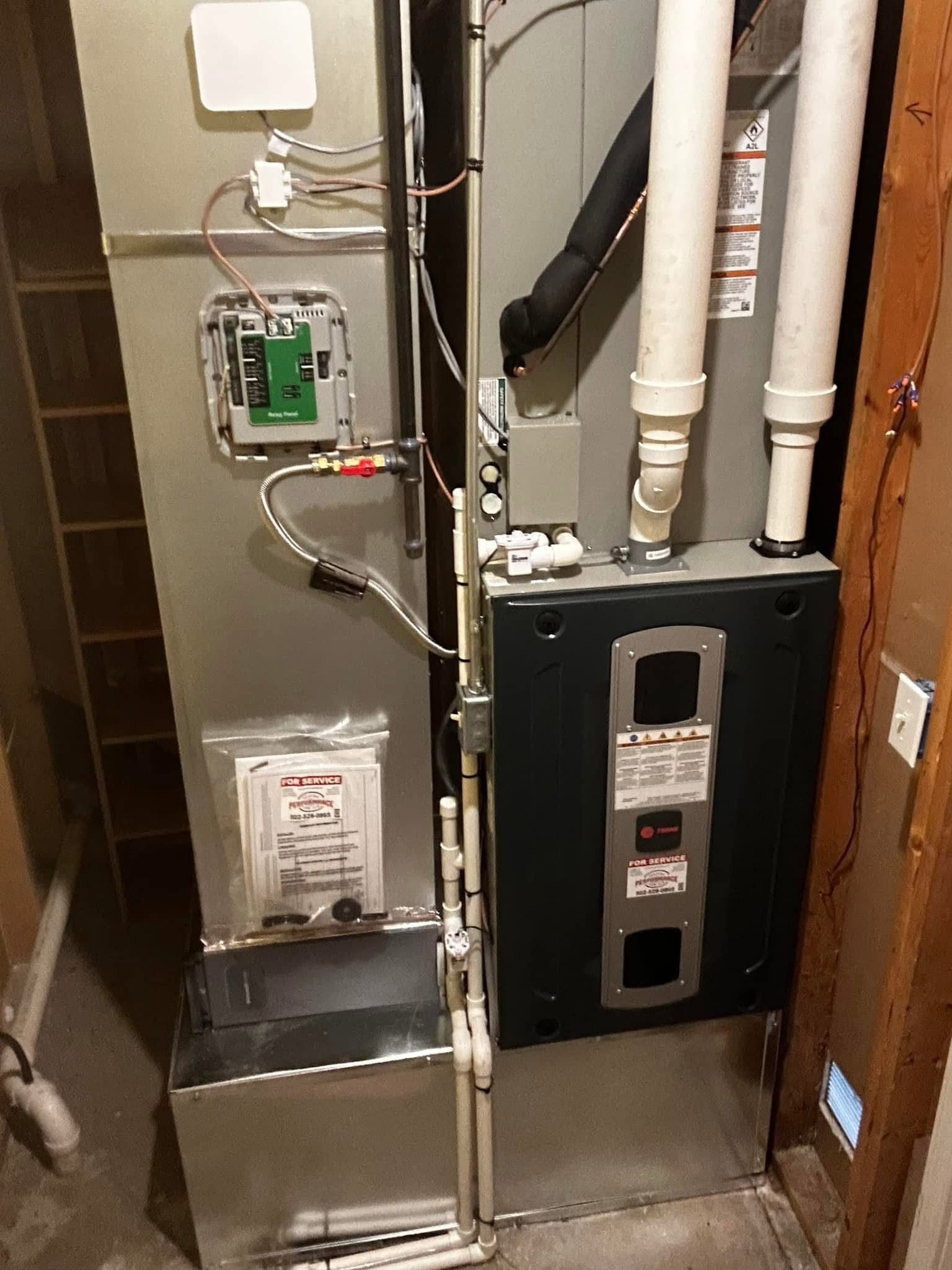 A picture of an air conditioner in a basement.