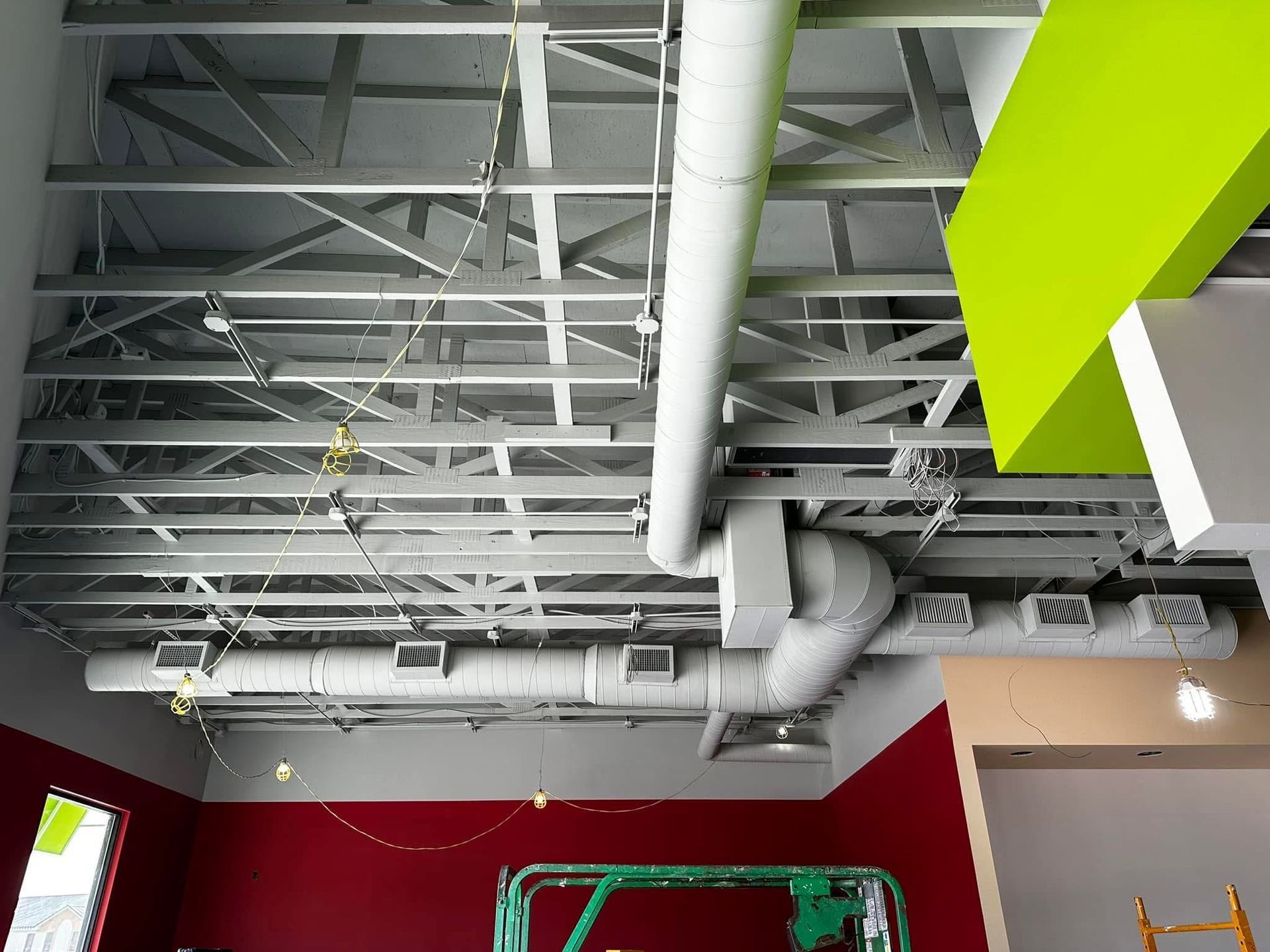 A ceiling with a lot of pipes hanging from it