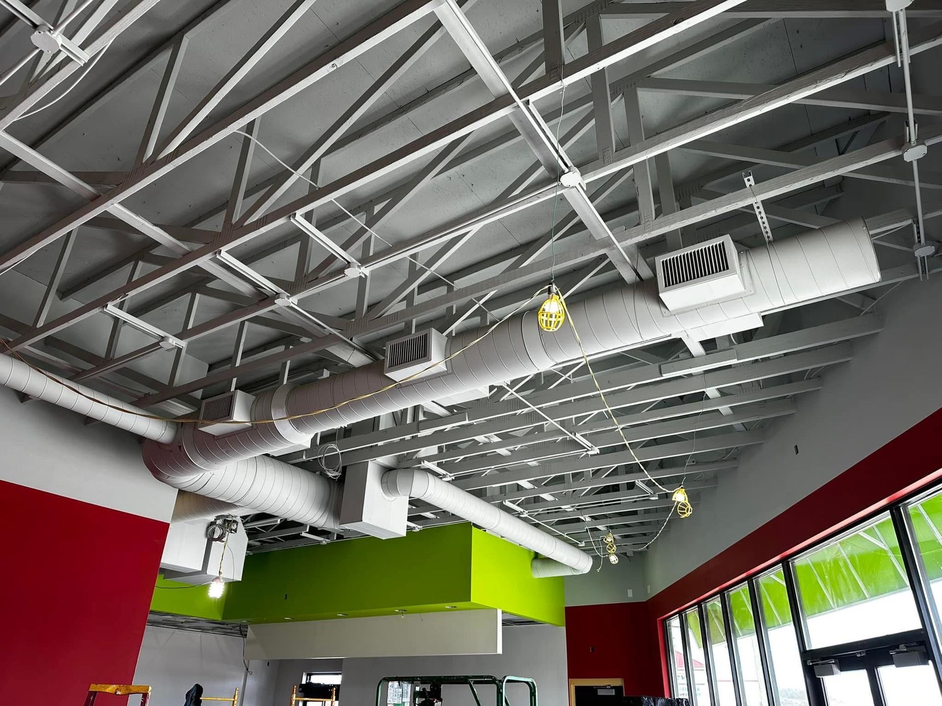 A ceiling with a lot of pipes hanging from it