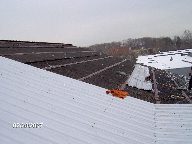 Professional repairing a roof in New Milford, CT