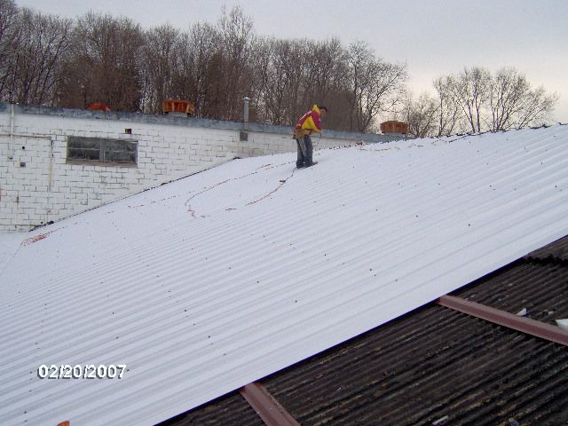 Professional repairing a roof in New Milford, CT