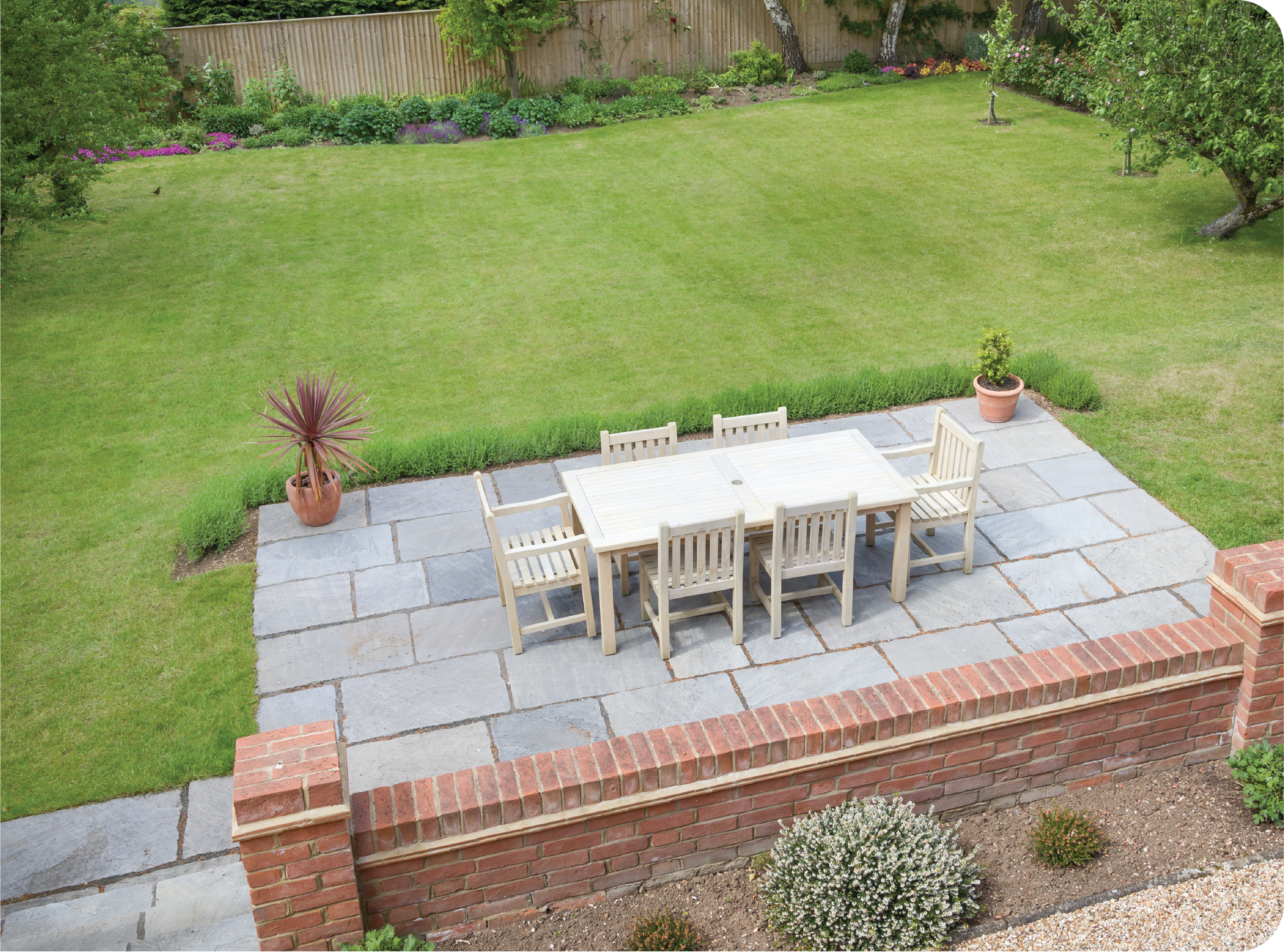 An aerial view of a patio with a table and chairs