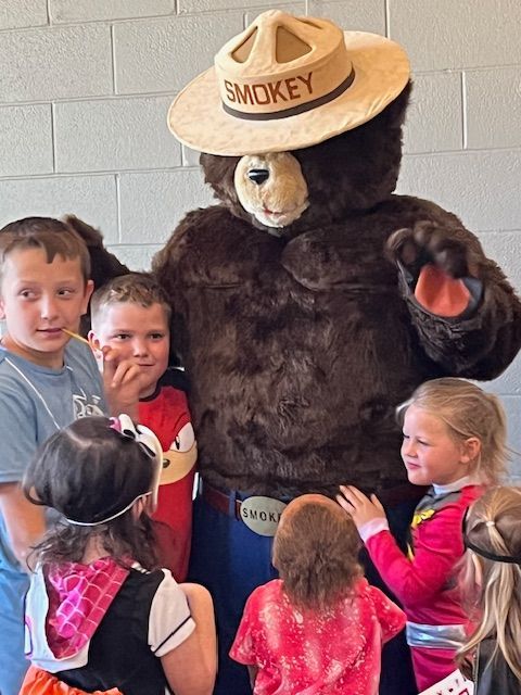 Smoky Bear visits the library