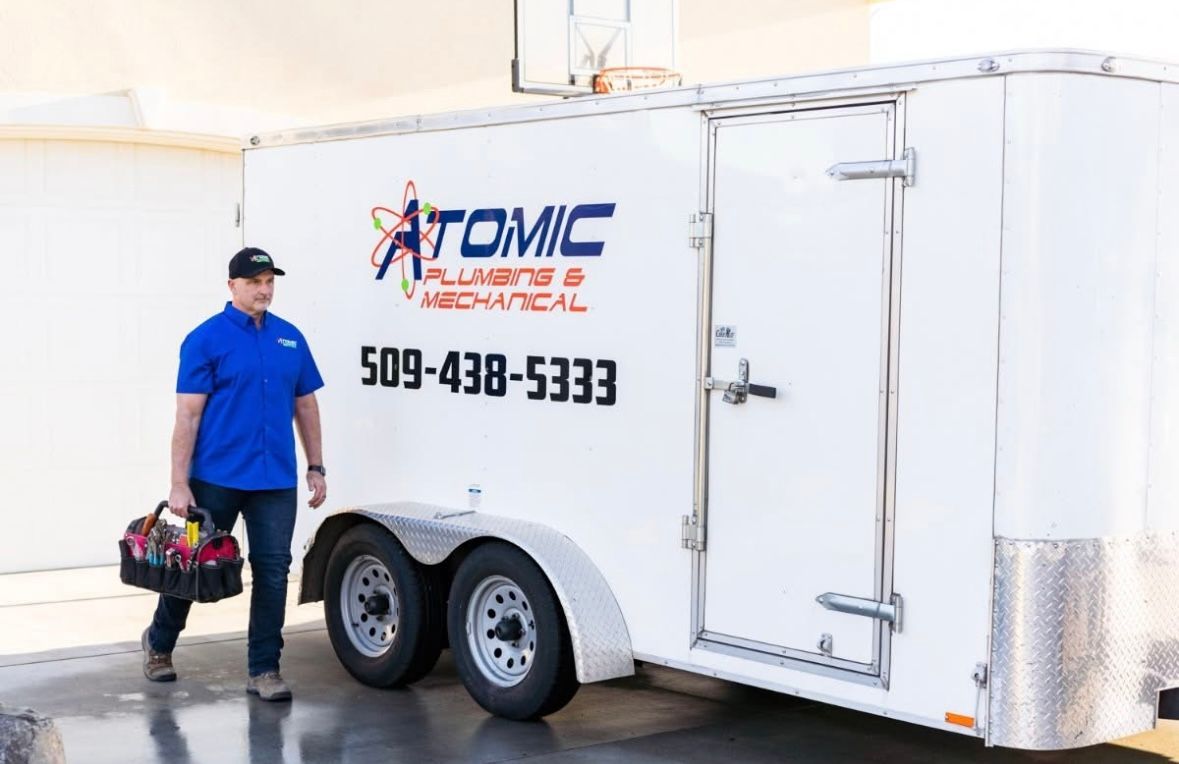Man with toolbox walking from white trailer with 