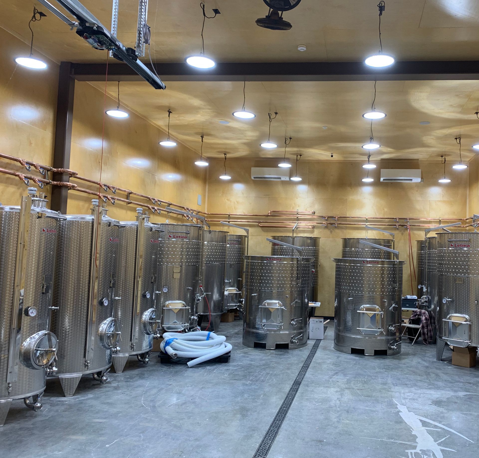 A large room filled with lots of stainless steel tanks