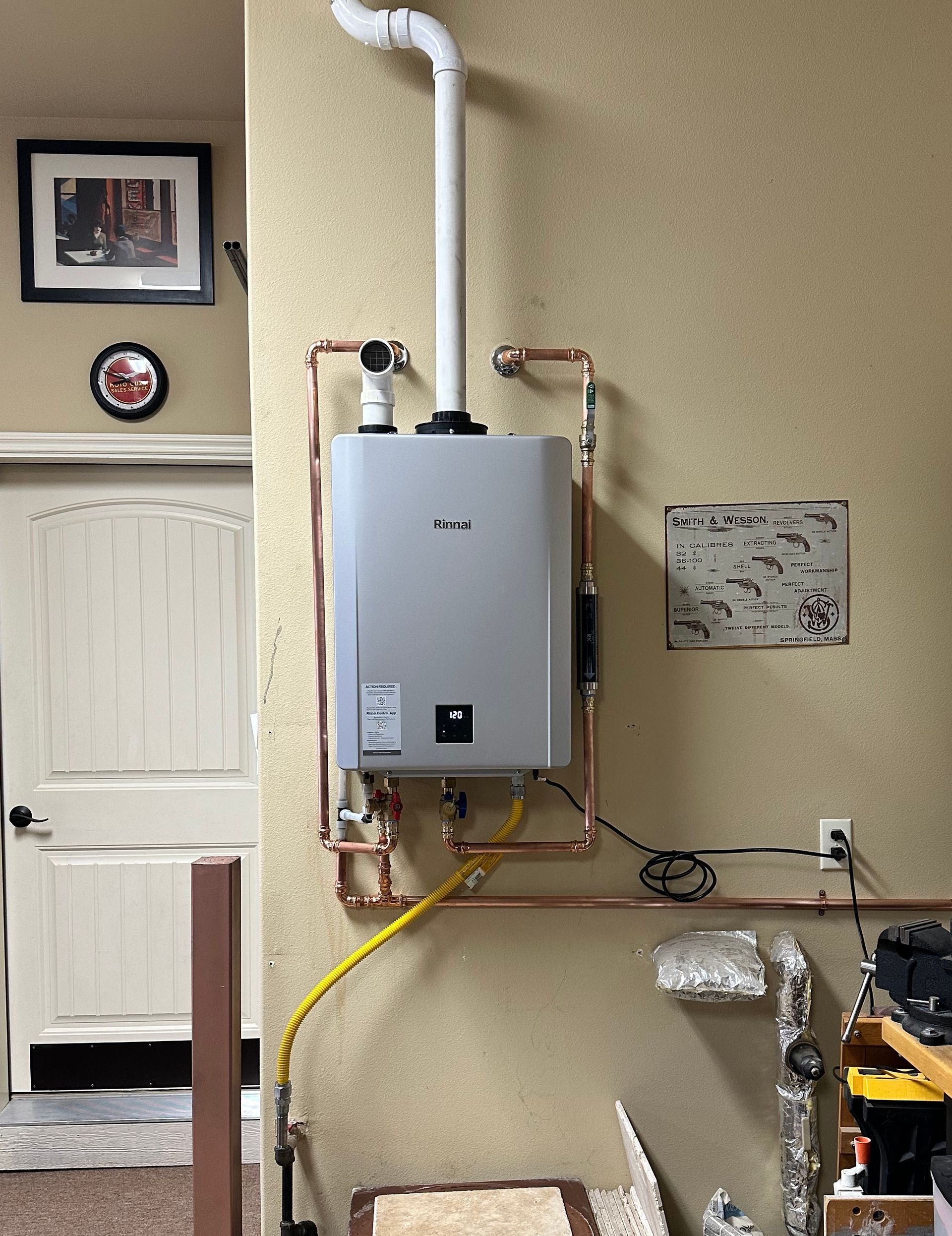 A water heater is mounted to a wall in a room