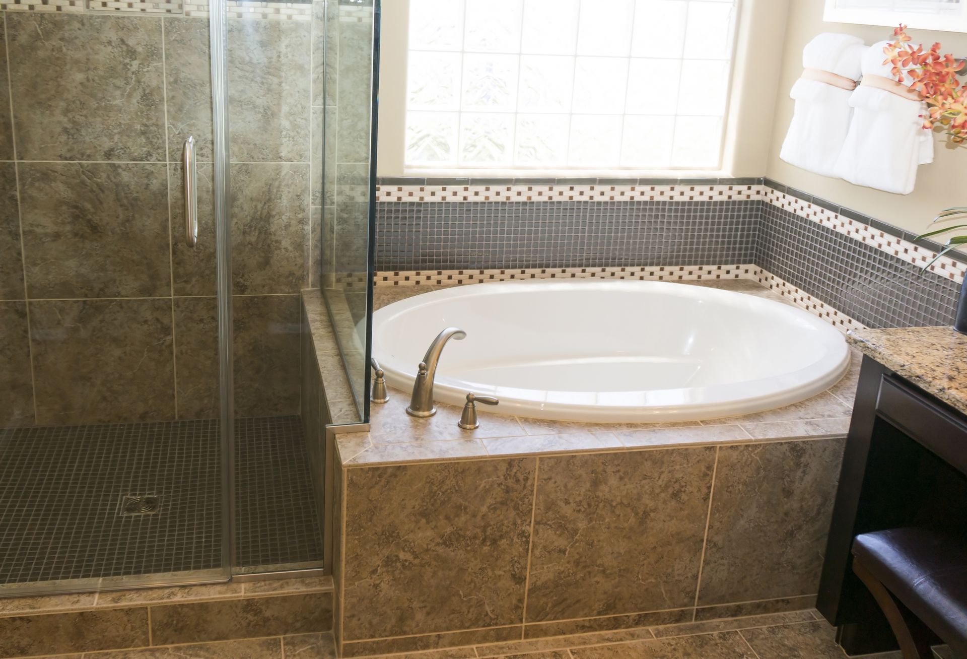 A bathroom with a tub and a walk in shower.