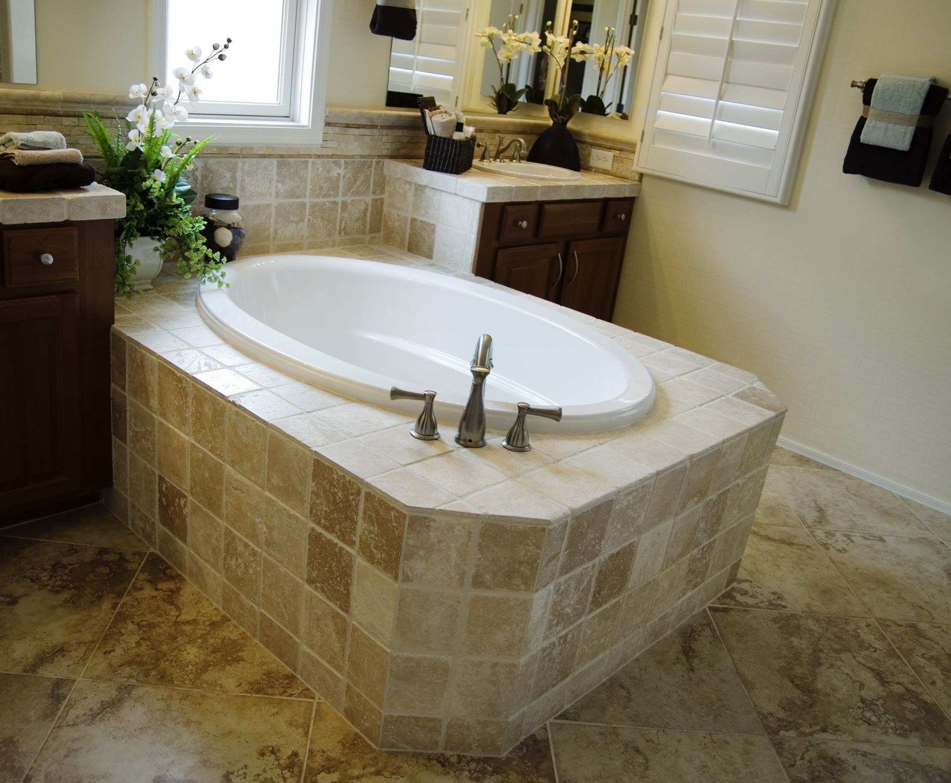 A bathtub in a bathroom next to a window