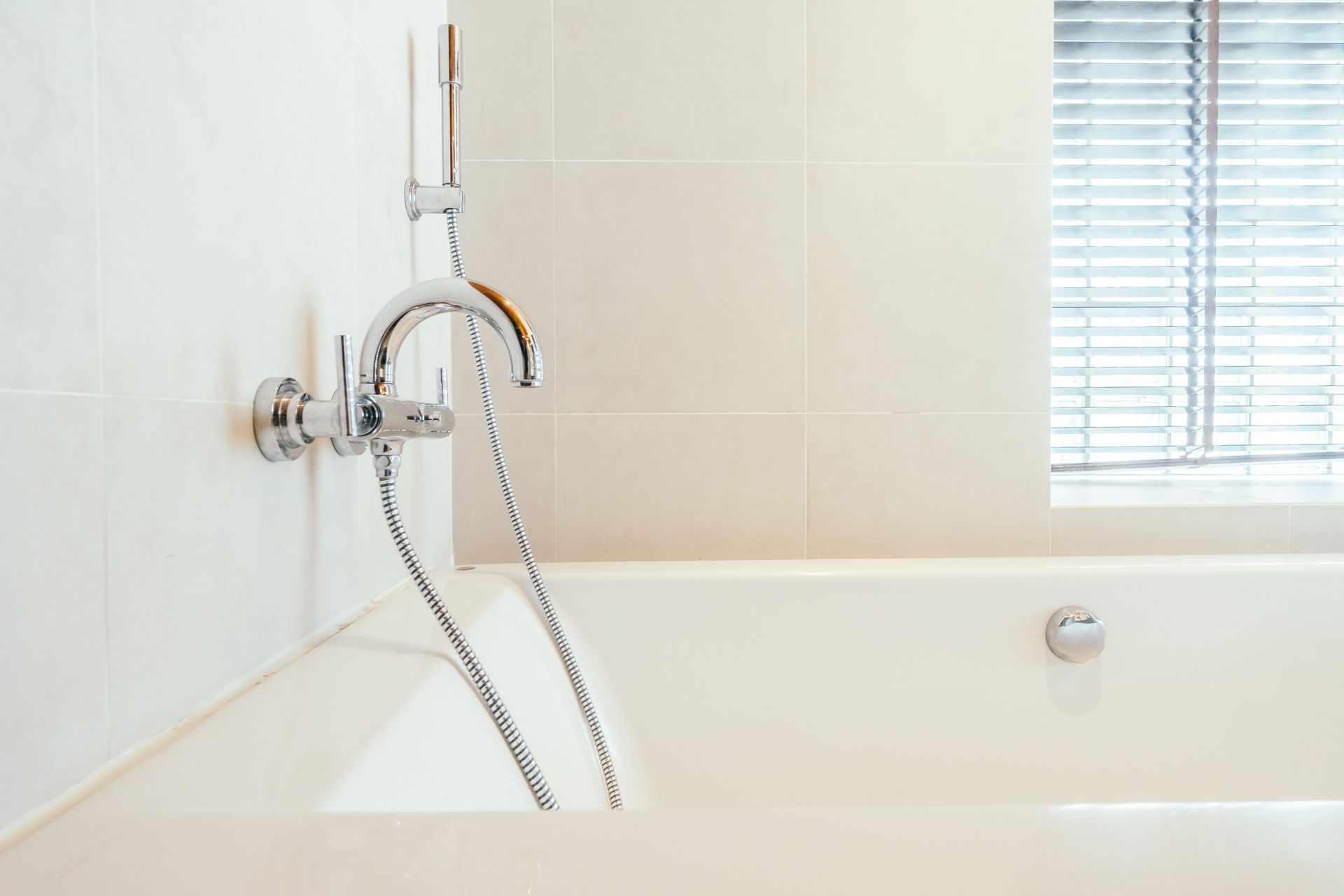 A bathtub with a shower head attached to it in a bathroom.