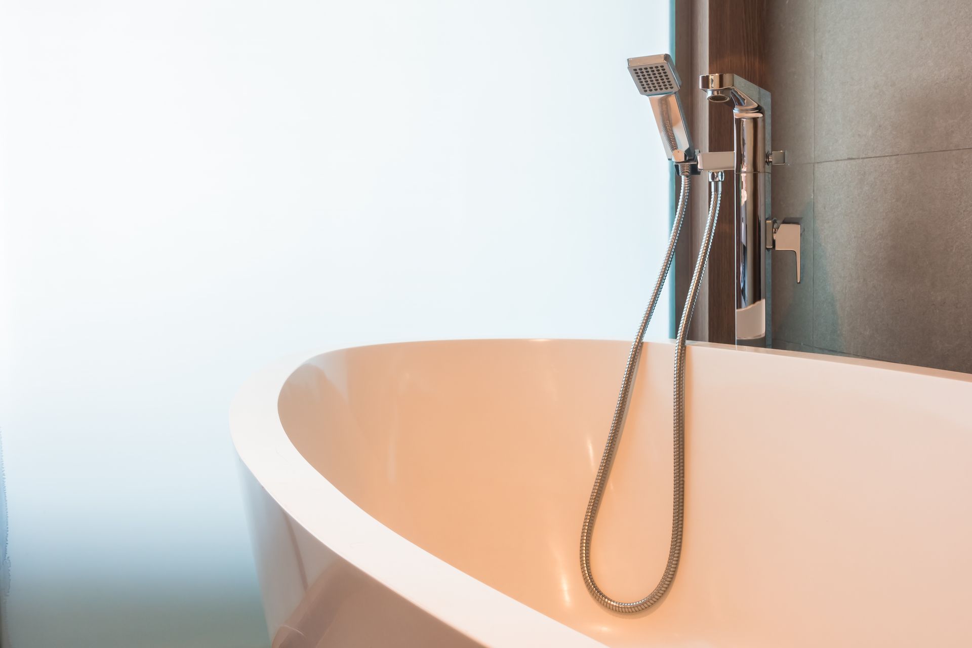 A bathtub with a shower head attached to it in a bathroom.
