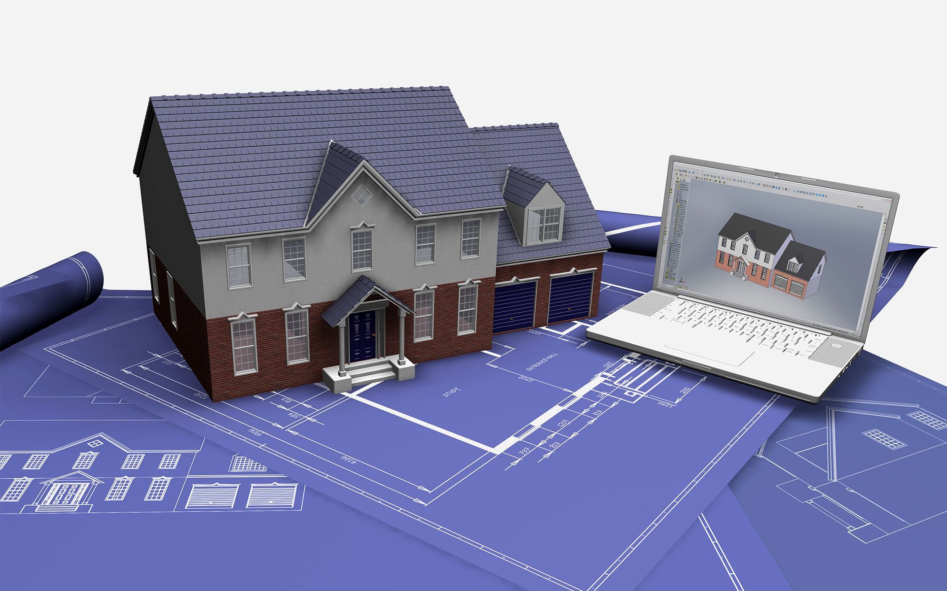 A model house is sitting on top of blueprints next to a laptop