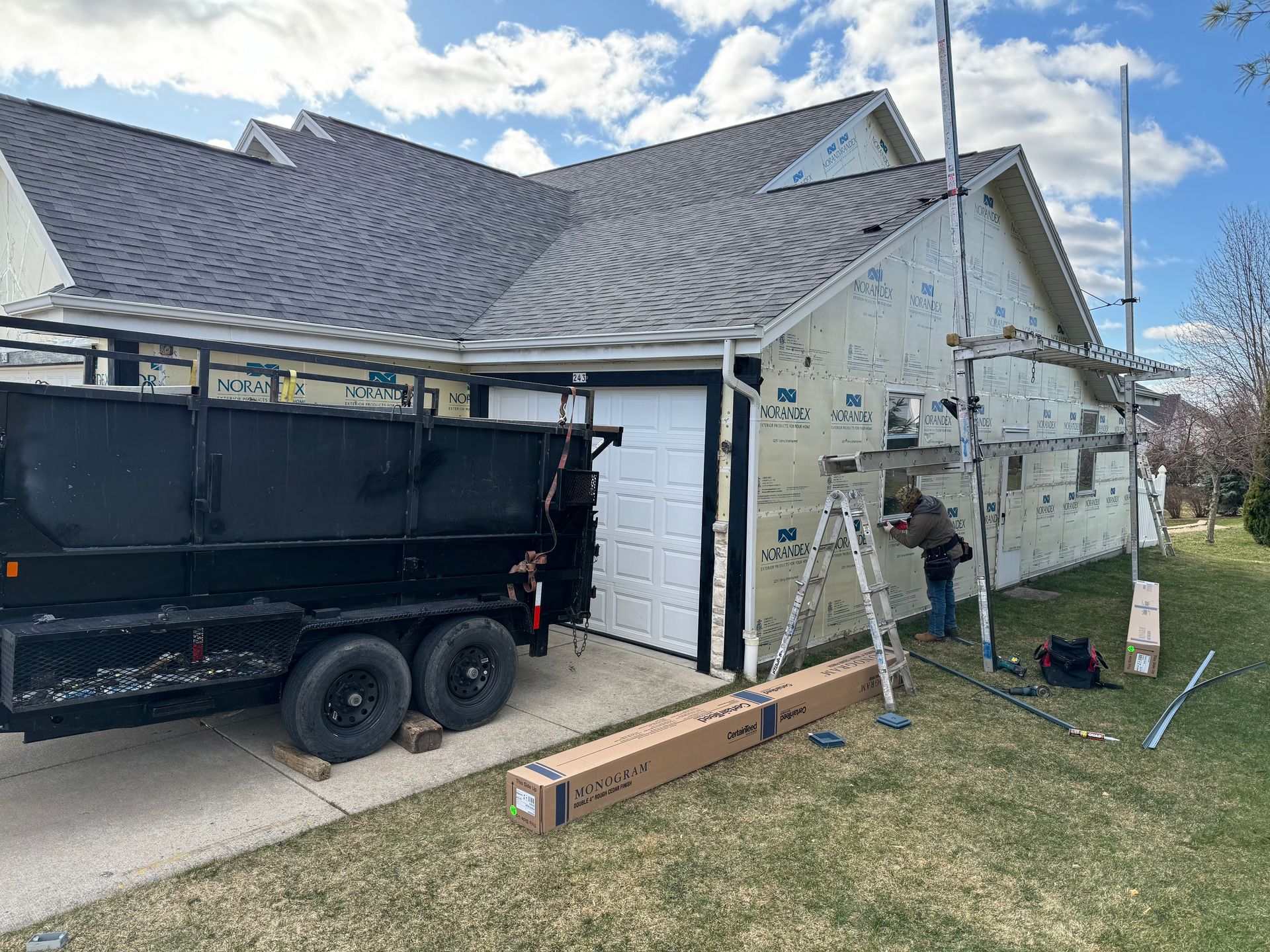 A dump truck is parked in front of a house.