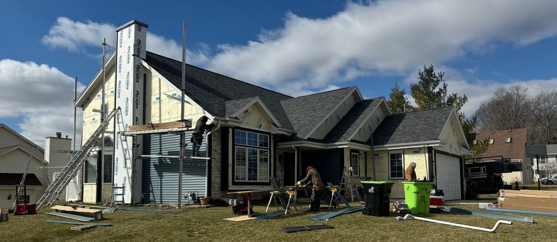 A large house is being remodeled in a residential area.