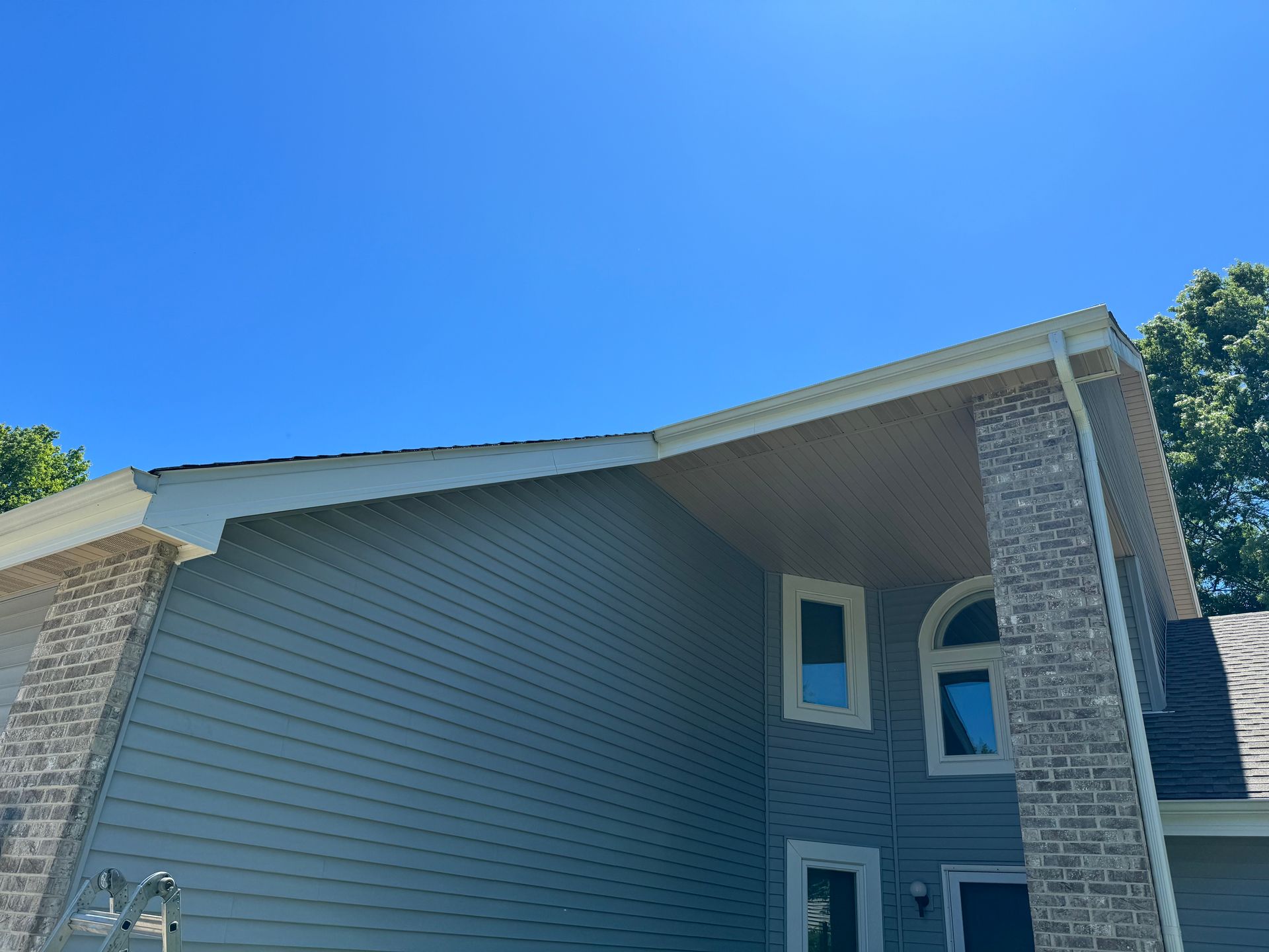 A large house with a blue sky in the background.